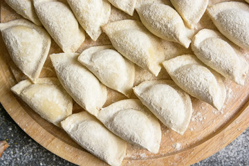 Cooking traditional Russian dumplings vareniki