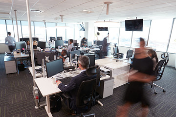 Interior Of Busy Modern Open Plan Office With Staff