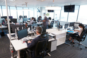 Interior Of Busy Modern Open Plan Office With Staff
