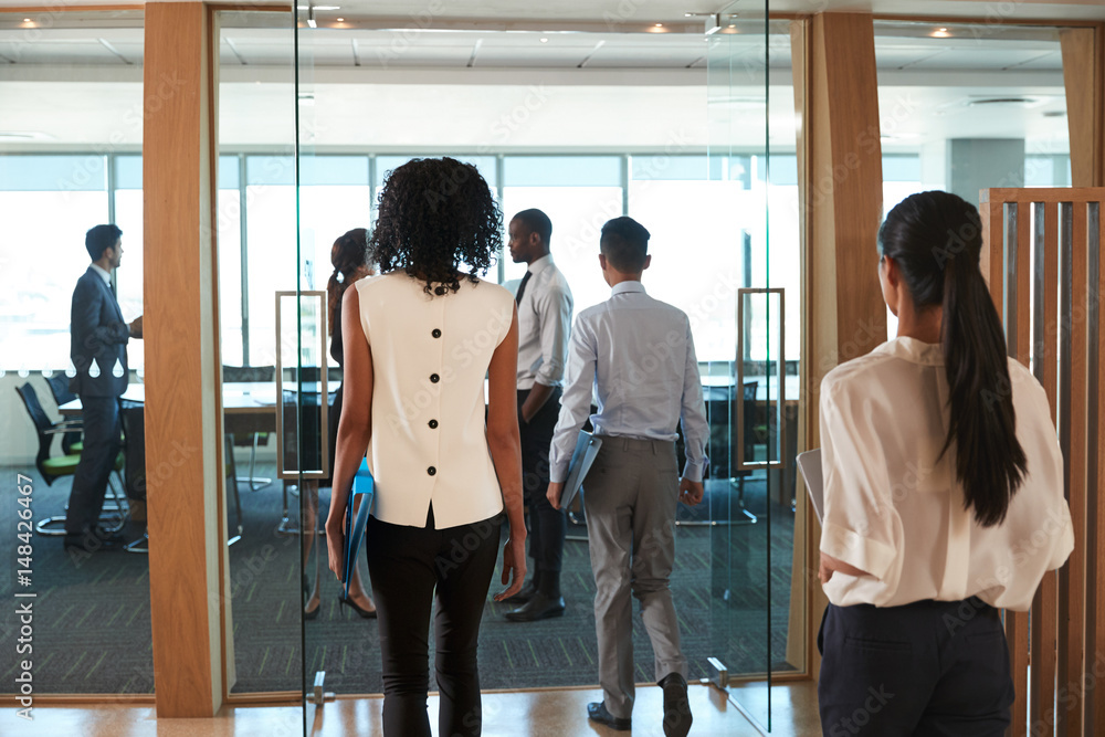 Wall mural rear view of businesspeople entering boardroom for meeting