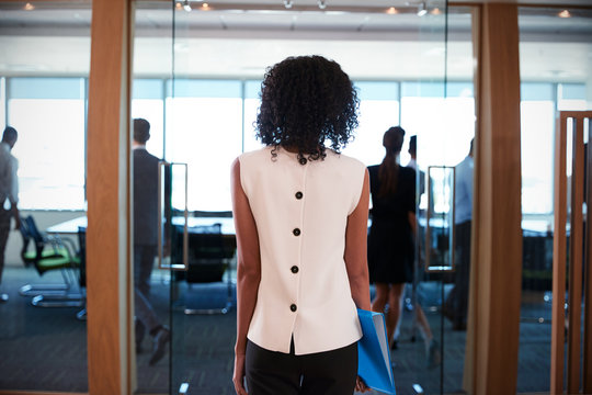 Rear View Of Businesswoman Entering Boardroom For Meeting