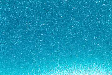 Macro sponge texture, blue bubbles.