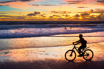 Fototapeta na wymiar Cycling on the beach, silhouette