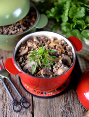 Buckwheat with chicken and mushrooms in a pot.