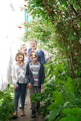 Family walking in pedestrian passage of small french village