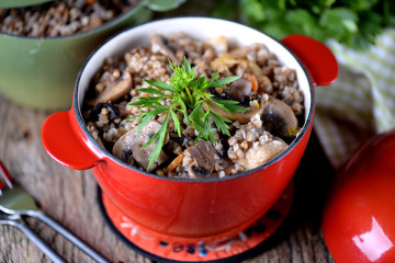 Buckwheat with chicken and mushrooms in a pot.
