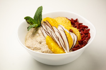 Porridge with coconut, orange and Goji berries. Theme of raw food, live food, healthy eating background