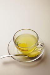 Herbal mint tea in a glass cup with lemon