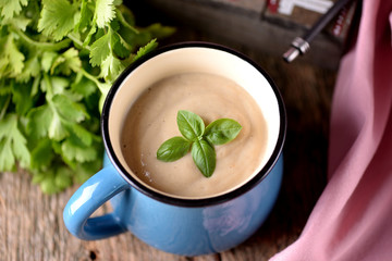 Chicken cream soup with cheese in mug.