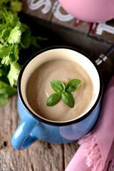 Chicken cream soup with cheese in mug.