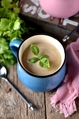 Chicken cream soup with cheese in mug.