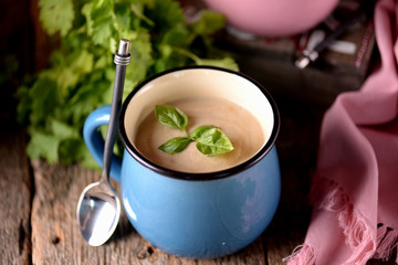 Chicken cream soup with cheese in mug.