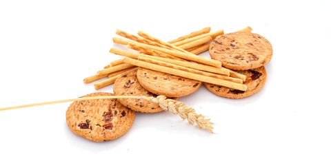 Cracker cookies and salty sticks on white background