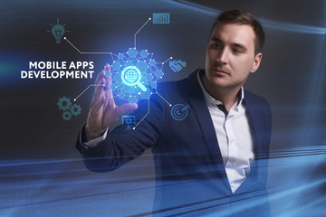 Business, Technology, Internet and network concept. Young businessman working on a virtual screen of the future and sees the inscription: Mobile apps development