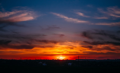 The sun sinks to the ground. Beautiful fiery sunset.