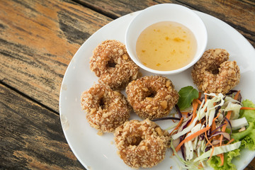 TOD-MUN-KUNG.THAI food on wooden table (wooden background)