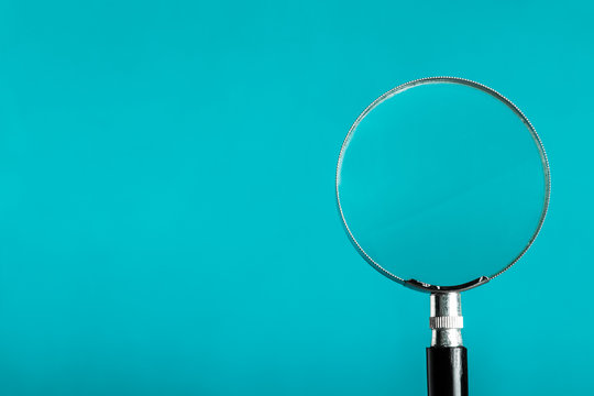 Magnifying glass on blue color background.