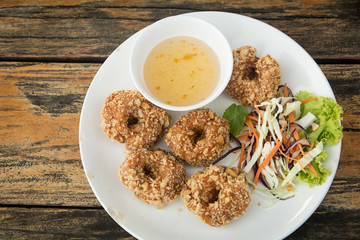 TOD-MUN-KUNG.THAI food on wooden table (wooden background)
