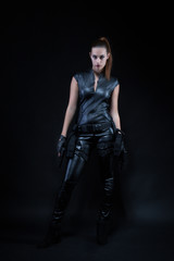 Superhero police woman in a leather catsuit with guns