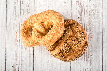 Fresh seedy breads on white wooden background