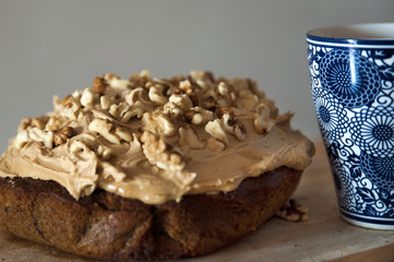 Inviting dessert with homemade walnut and coffee cake and a large, colorful cup of coffee or tea