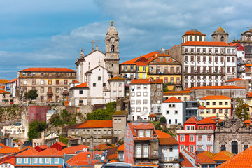 Fototapeta na wymiar Aerial view with traditional multicolored quaint houses in Old town of Porto in the sunny day, Portugal