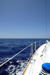Boat in the azure, clear Atlantic Ocean or port side of luxury yacht navigating along the coast of Canary Islands, Spain
