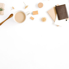 Blogger or freelancer workspace with coffee mug, notebook, sweets and accessories on white background. Flat lay, top view minimalistic brown styled home office desk. Brown styled composition