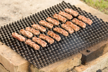 Grilling kebabs on the barbecue grill. Selective focus on the minced meat kebabs