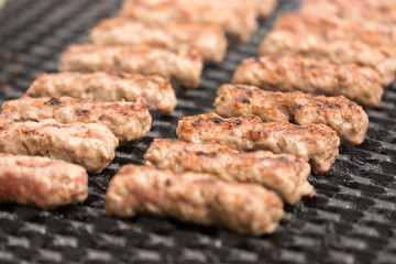 Grilling kebabs on the barbecue grill. Selective focus on the minced meat kebabs