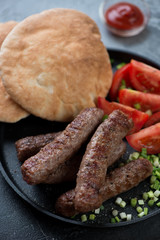 Close-up of barbecued cevapcici or skinless beef sausages, traditional dish in the Balkans