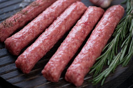 Close-up of raw cevapi or cevapcici sausages, selective focus, horizontal shot