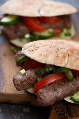 Close-up of bbq cevapi or skinless beef sausages served in pita bread, selective focus, shallow depth of field