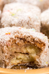 Sliced chocolate cakes with coconut closeup macro