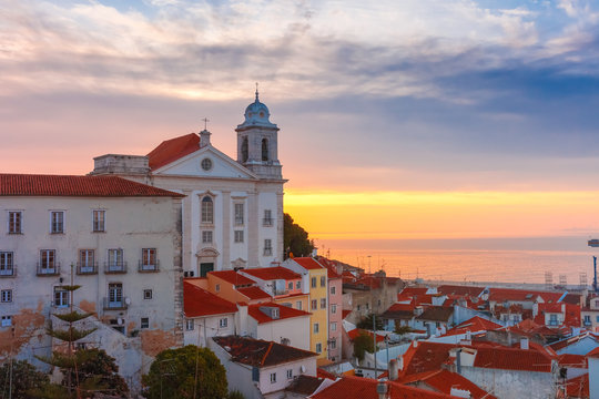 View of Alfama, the oldest district of the Old Town, with Church of Saint Stephen at cloudy sunrise, Lisbon, Portugal