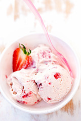 Strawberry cream ice cream in white bowl 