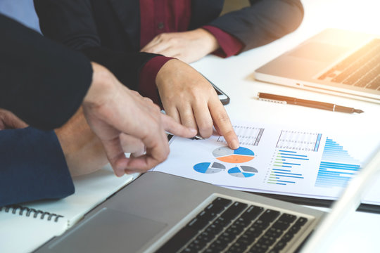 Business team meeting working with new startup project.discussion and analysis data the charts and graphs. Digital tablet laptop computer using,Business finances and accounting concept - Powered by Adobe
