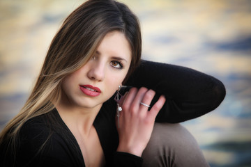Fototapeta premium Young attractive woman near the sea on a spring day