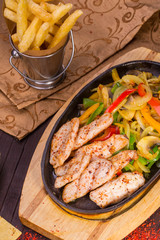 Meat from pieces with onions and champignons, fried in soy sauce and spices
