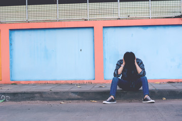 Lonely man sitting on the street