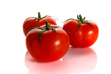 Red ripe tomato with the handle isolated on white background