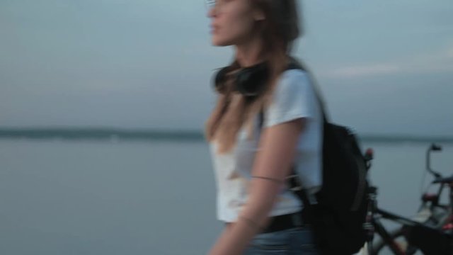 Beautiful woman roller-blading on the seashore 4k