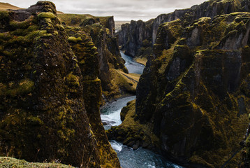 River running in between huge rocks, Fjadrargljufur Canyon in Iceland
