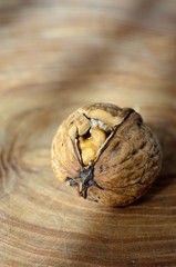 Fototapeta premium Broken walnut on surface wood of radial cut 