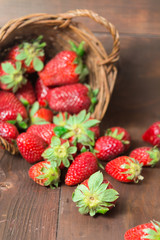 Fall put basket of strawberry on wooden table