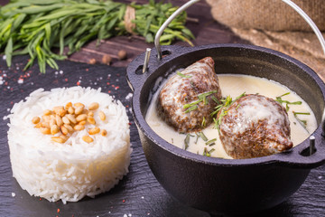 The meat meatballs baked in sour-milk sauce is served with spicy rice