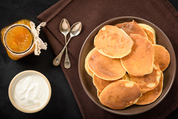 Homemade pancakes on black background.