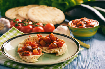 Pita bread with vegetable spread- mediterranean kitchen style.