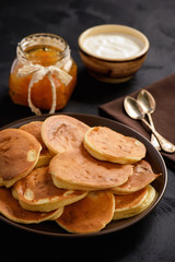 Homemade pancakes on black background.