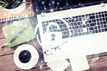 Business workplace with laptop coffee cup and security concept o